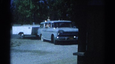 1962: a vehicle with many passengers and a trailer arriving CATSKILL, NEW YORK