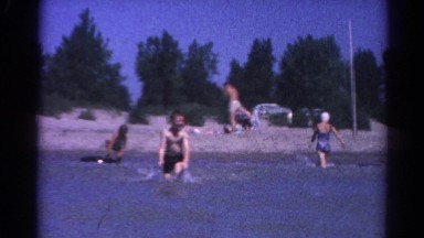 1962: people play in the water of a man-made beach. CATSKILL, NEW YORK