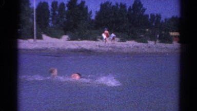 1962: a girl and a boy are playing in the water