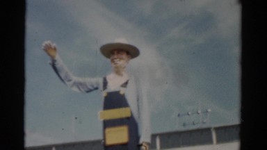 1957: Marketplace Gathering of Visitors Near Tall Statue of a Farmer Catskill