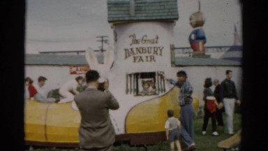 1957: Kids Frolic and Play While Parents Watch at a Fair with Activities