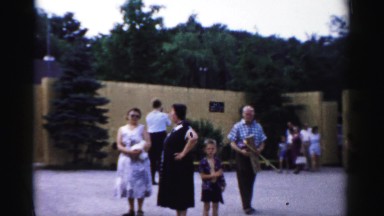 1957: various people gathered outdoor a wall or a compound CATSKILL, NEW YORK