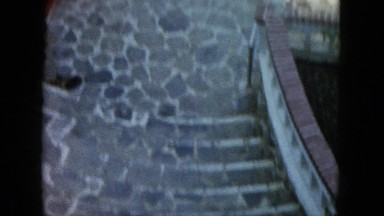 1962: a view of a woman from above, walking down a dramatic outdoor landing