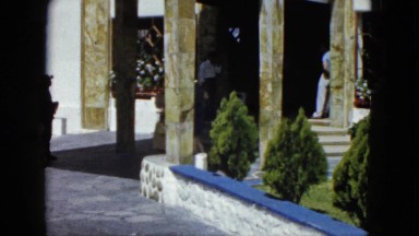 1962: man and woman exchanging money with stripe outfit 1950s glasses columns