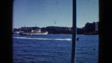 1962: a backwater with vessels moving, anchored etc with shore rich of greenery