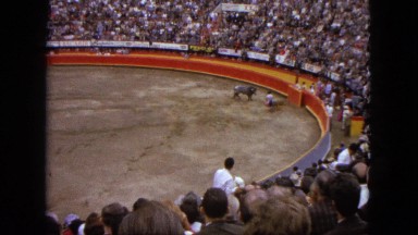 1962: a bull charging and attacking a bull fighter in a stadium MEXICO