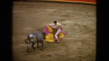 1962: a man working as a torero in a bullring assisted by another torero MEXICO