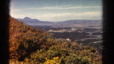 1967: Beautiful Daytime View of Nearby Forest and Mountains in the Distance