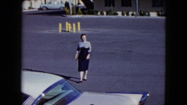 1959: woman walking dressed bread carrying road street LAS VEGAS, NEVADA