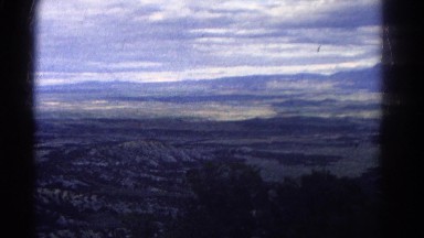 1967: a man is enjoying the panoramic view of vast land under the overcast sky