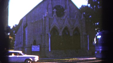 1967: a church with a car and bus parked outdoor. COLORADO