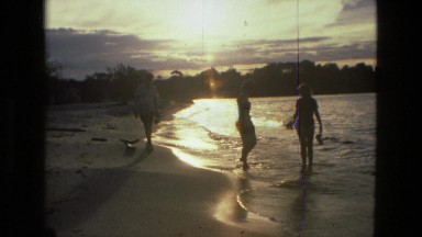 1979: An Older Woman and Two Female Teenagers Walk Along a Beach at Sunset