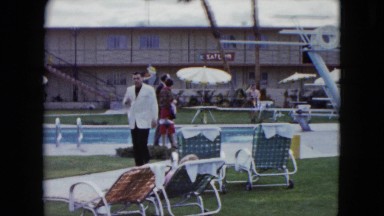 1959: Suited Man Walking Near Swimming Area at Arizona Resort Hotel