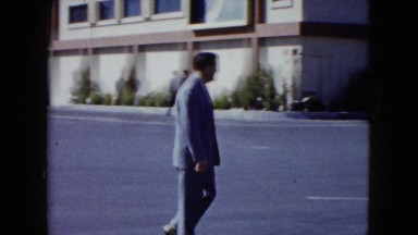 1959: a well dressed man walking through a parking lot to his car ARIZONA