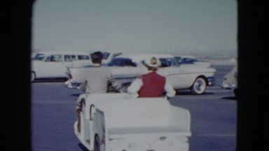 1959: a woman is transferred in a small transport to her car