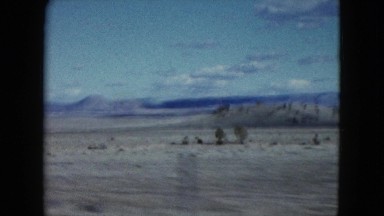 1959: a beautiful desert and rugged mountain ridgeline with a bright blue sky