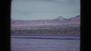 1959: Meadows and Low Mountains to the Side of the Road on a Slightly Overcast