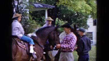1961: Two Boys on Horses Ready for Ride with Jockeys Standing in Michigan