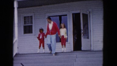 1961: father and daughters hold hands and walk down front porch steps MICHIGAN