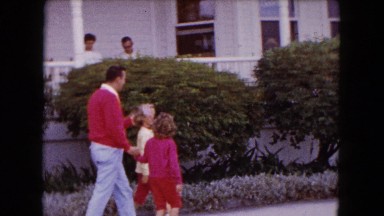 1961: father walking down the street with two daughters, couple sitting on porch