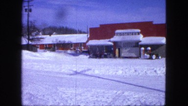 1963: an suv attempts to clear a road that is covered in snow. MAINE