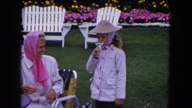 1961: a family seated at a table out on the lawn having drinks MINNESOTA