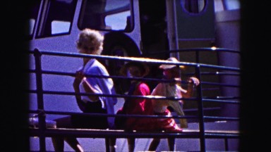 1961: family sitting on a dock and waving beside a boat MINNESOTA