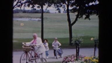 1961: people are walking their bikes on a pretty road MINNESOTA