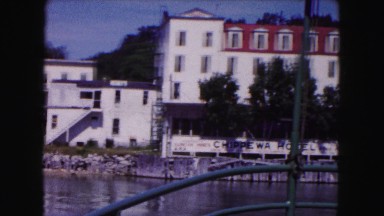 1961: a beautiful view of a coastal city or town with buildings on the water