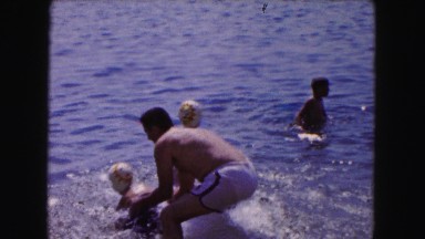 1961: dad is playing with his kids in the water MINNESOTA