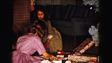 1961: mom and two daughters opening presents on christmas morning MINNESOTA