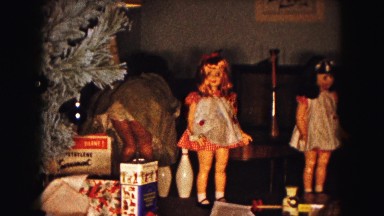 1961: a girl checking her christmas presents surrounded by large dolls MINNESOTA