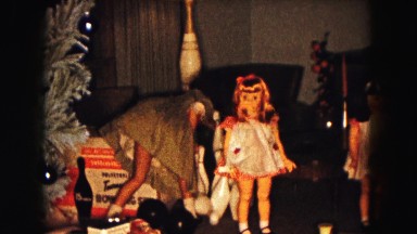 1961: a girl playing with her toys at christmas