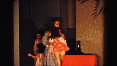 1961: two girls wearing pajamas and robes with life-size dolls