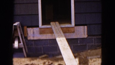 1954: a view of wood and tools on a construction site outdoor a house