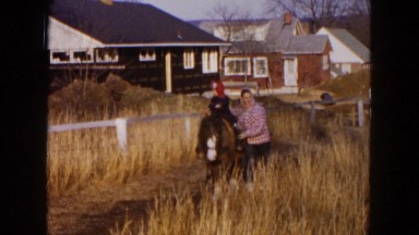 1954: the mother and son take a nice stroll along the farm HICKSVILLE, NEW YORK