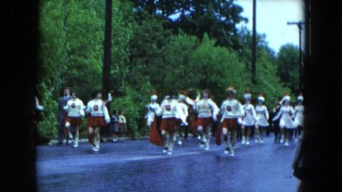 1954: various people marching through the street in a parade HICKSVILLE