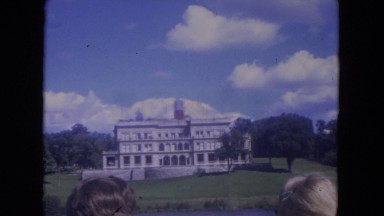 1972: building banner trees brick wall fence white huge water trees WISCONSIN