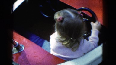 1954: Children Driving and Riding Motorboats on Tracks at Amusement Park