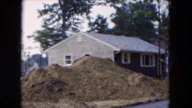 1954: view of houses and new construction in a wooded neighborhood HICKSVILLE