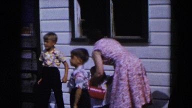 1954: a well dressed group including kids walking away from a house HICKSVILLE