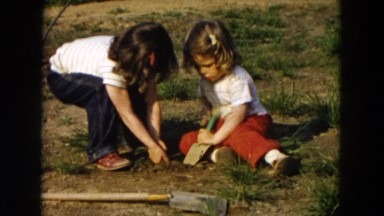1955: children having fun digging dirt in backyard HICKSVILLE, NEW YORK