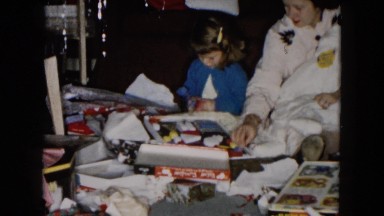 1955: mother and daughter opening presents on christmas day HICKSVILLE, NEW YORK