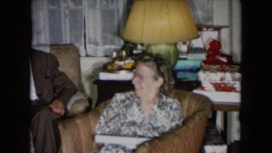 1955: an elderly man and woman sit in front of a window in a house talking