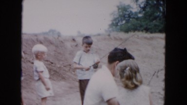 1955: a father teaching his little daughter how to fish for the first time