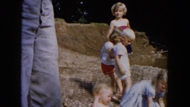 1955: various young children playing in the mud on the water's edge HICKSVILLE