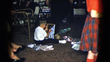 1958: a young girl handing out christmas gifts to the family NEVADA