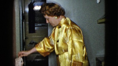 1958: woman in yellow jacket taunting a dog with a toy dog NEVADA