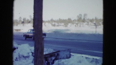 1958: a car drives down a highway passing a mobil gas station