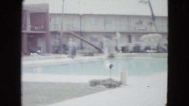 1958: a large swimming pool surrounded by apartments or motel rooms NEVADA